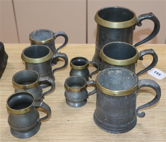 Nine brass rimmed pewter measures, Victorian/Edwardian